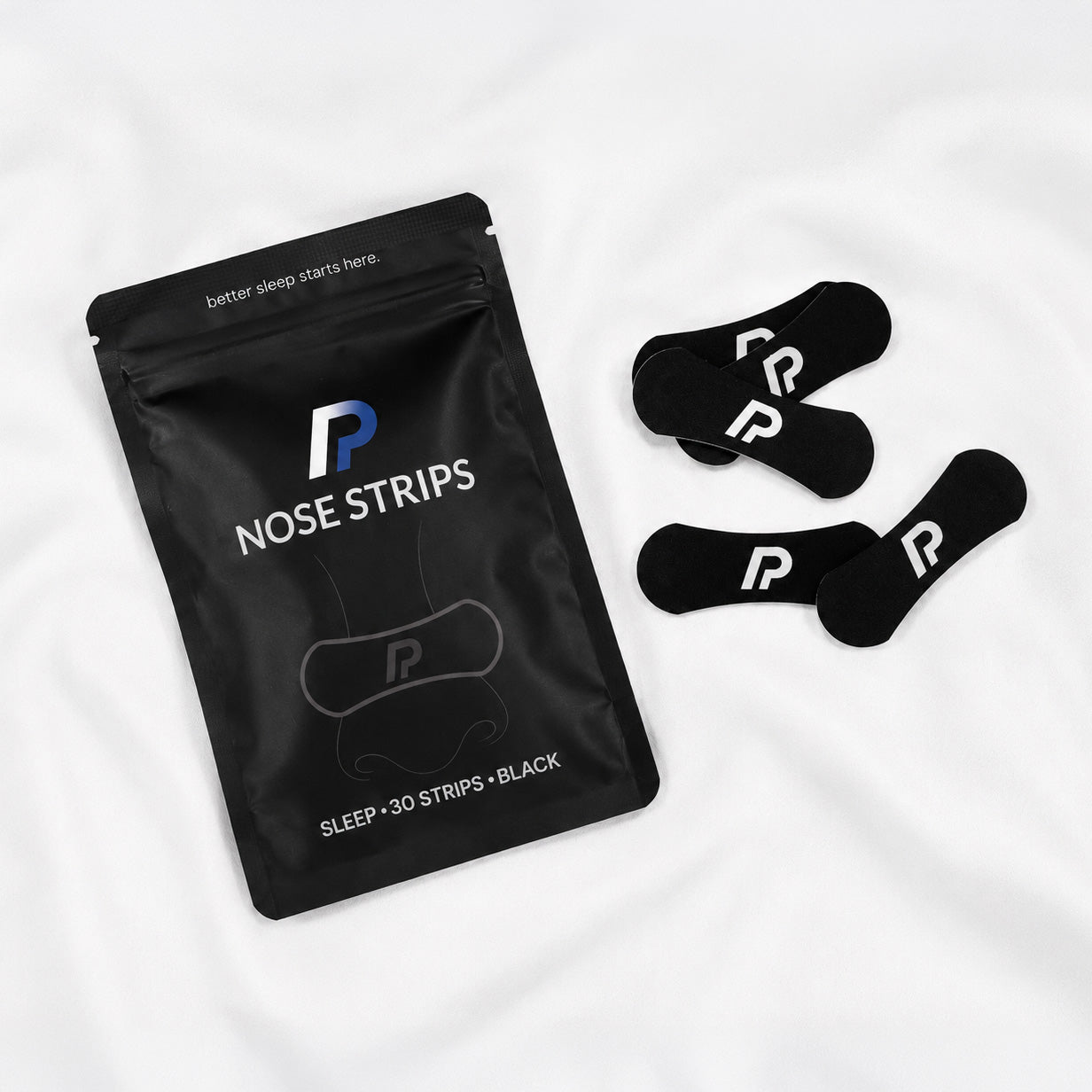 ProActive Health nose strips pouch with black nasal strips on white bedding