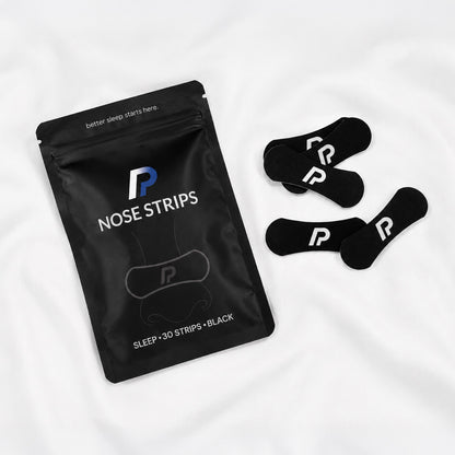 ProActive Health nose strips pouch with black nasal strips on white bedding