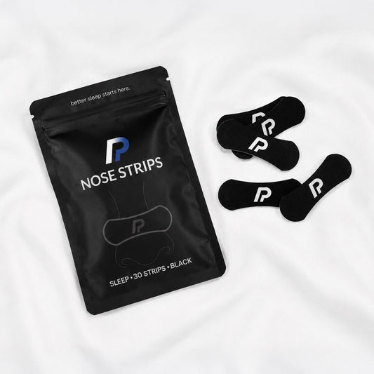 ProActive Health nose strips pouch with black nasal strips on white bedding