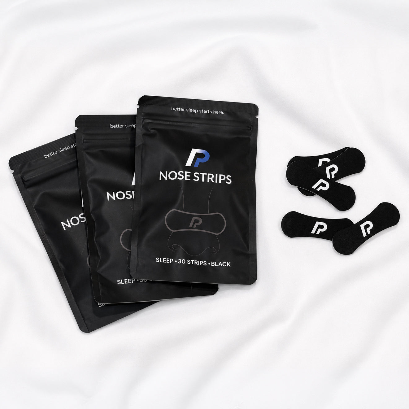 nose strips bundle with black nasal strips on white bedding