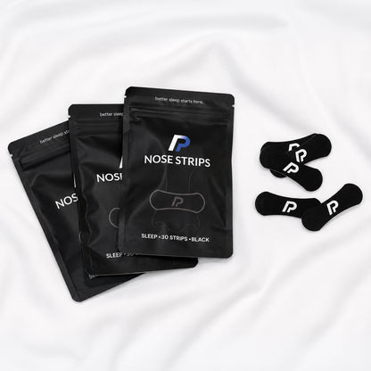 nose strips bundle with black nasal strips on white bedding