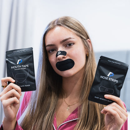 Woman holding a nose strips pack and mouth tape pack while wearing black mouth tape