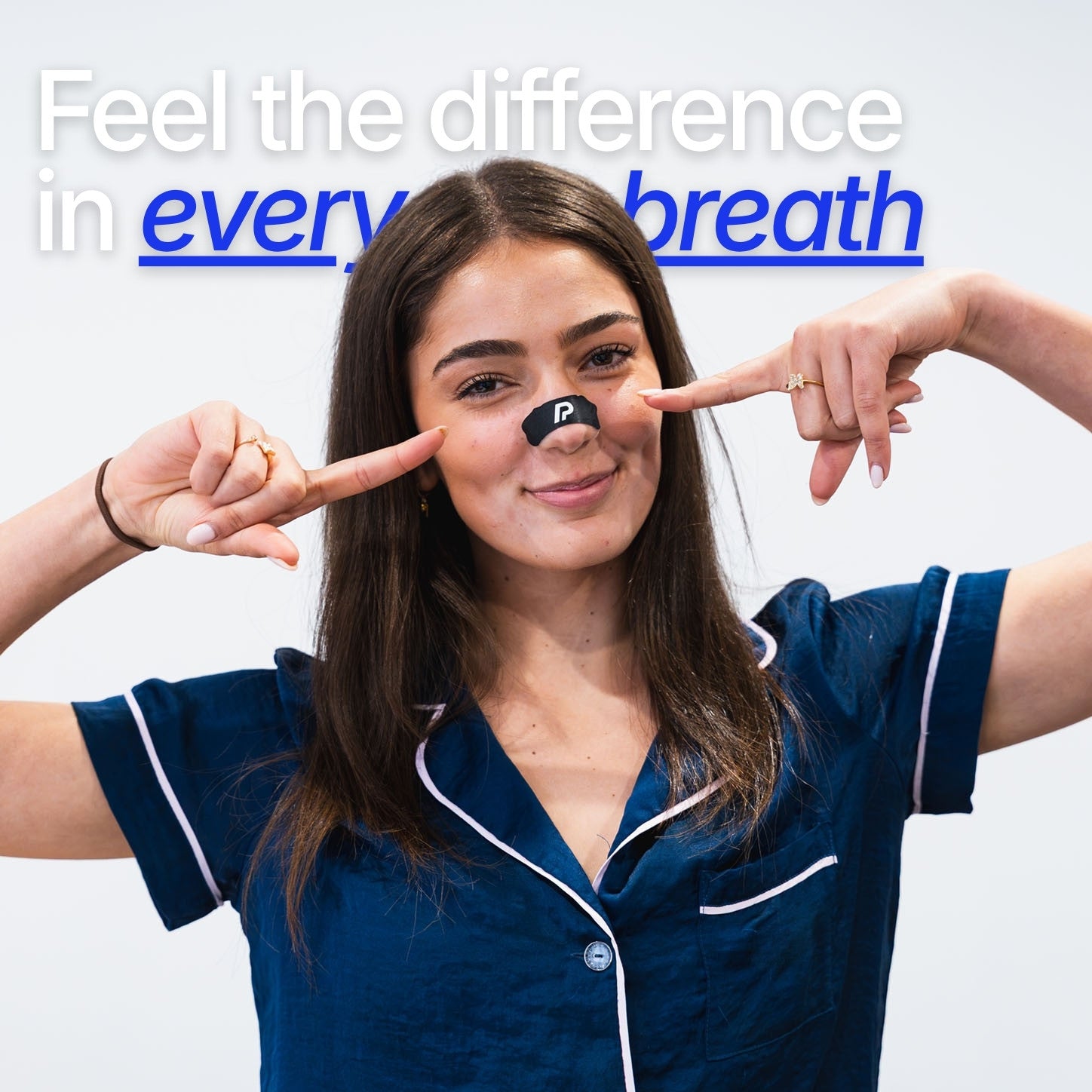 Woman pointing to a black nasal strip on her nose